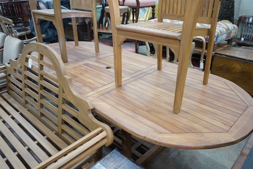 An extending teak garden table, length 140cm extended, width 100cm, height 75cm, a Lutyens style teak garden bench and two elbow chairs with waterproof covers